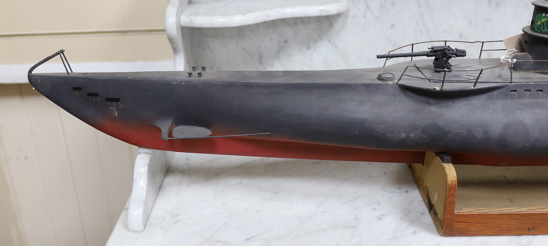 A painted wood model of a German U boat, 170 cms long
